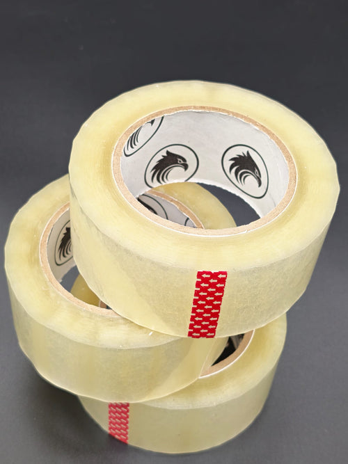 Phoenix Global 2 inch by 110 yard clear BOPP packing tape, single roll on dark studio backdrop
