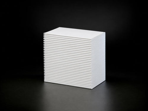 Fanfold stack of cold-chain direct thermal labels, dark studio backdrop