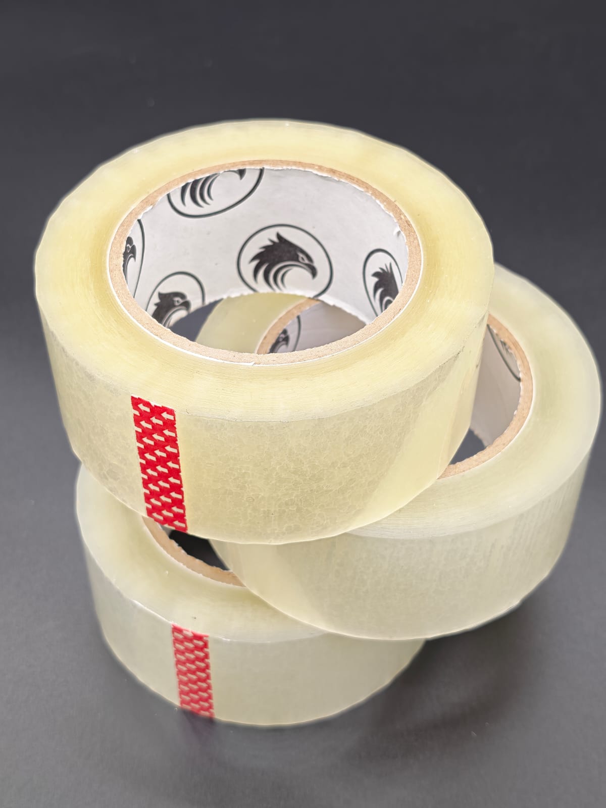 Phoenix Global 2 inch by 130 yard BOPP packing tape, single roll on dark studio backdrop