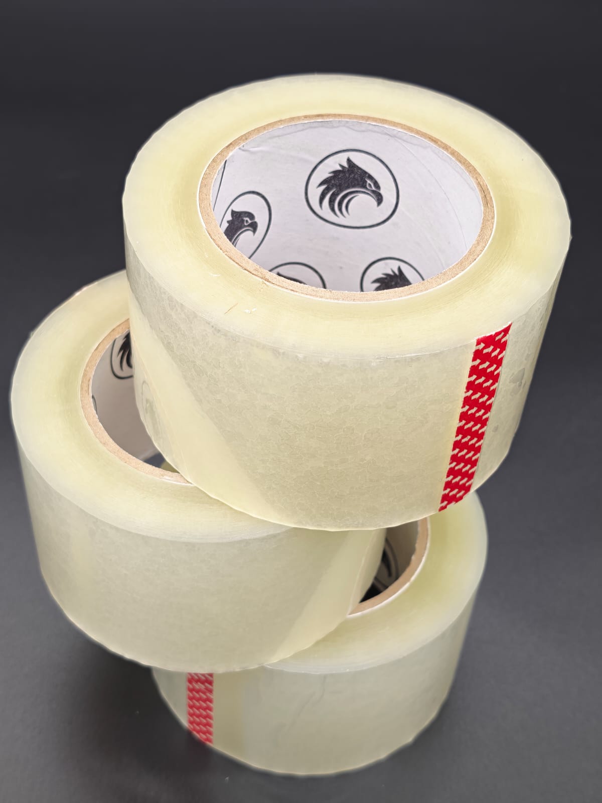 Phoenix Global 3 inch by 145 yard BOPP packing tape, single roll on dark studio backdrop
